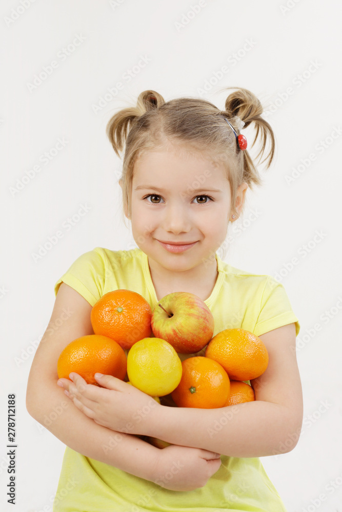Have some vitimines in witner. Cute 5-year-old girl holding fruits available in winter time. Have some vitimines in witner. Cute 5-year-old girl holding fruits available in winter time.