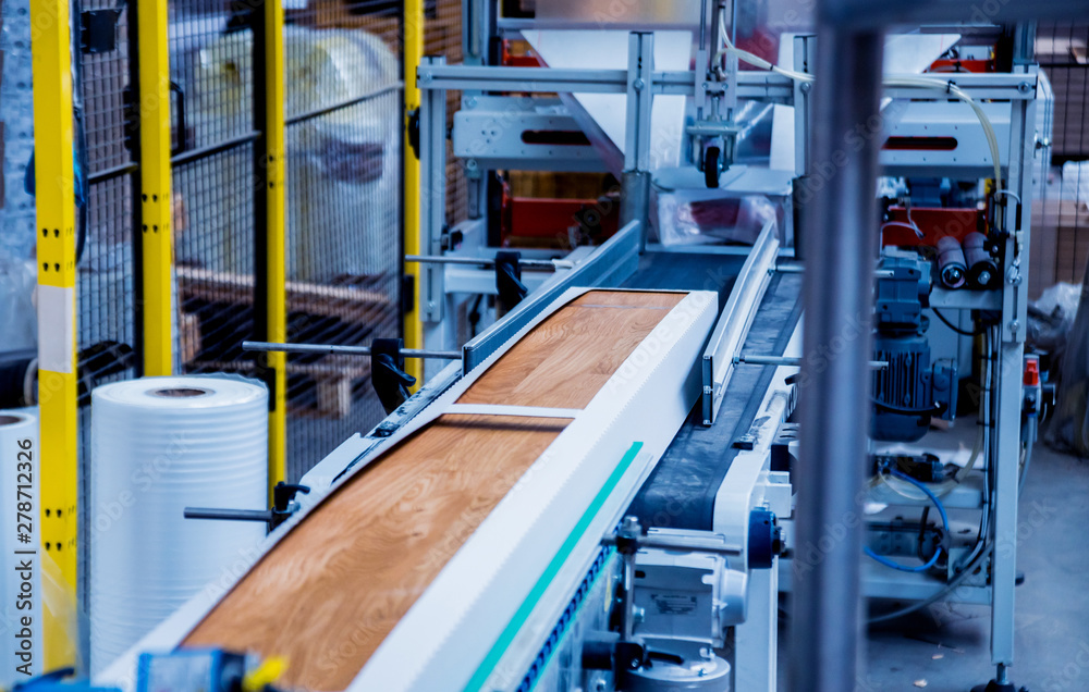 Production line of the wooden floor factory. CNC automatic woodworking machine. Production line of the wooden floor factory. CNC automatic woodworking machine.