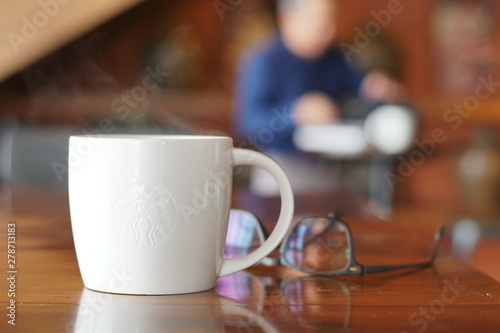 Hot coffee on wooden table  The espresso prefect shot  fresh coffee with smoke. Business time with coffee  selective focus and free space for text  Industrial food and drink concept.