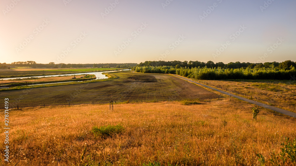 In the eastern Netherlands there is a valley of the river Vecht (Vechtdal in Dutch). The sun is setting at the valley near the village Marienberg. Photo is taken from a viewing point called Distelbelt