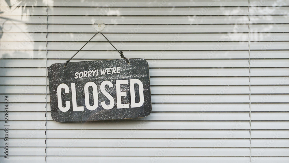 open and closed sign in the window with blind shade background Stock