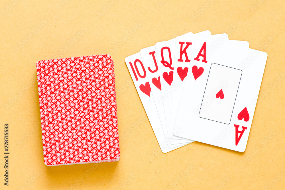 A royal straight flush playing cards poker hand in hearts.