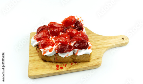 Toast Fruit Strawberry on topped whip cream in a wood plate isolated on white background, Food concept Front view.