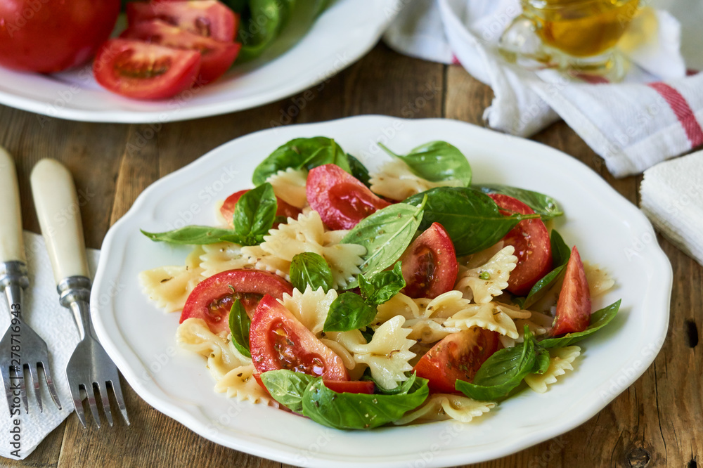 Farfalle pasta salad with tomatoes and green basil Farfalle pasta salad with tomatoes and green basil