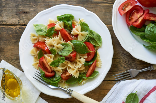 Farfalle pasta salad with tomatoes and green basil