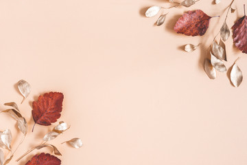 Autumn composition. Golden eucalyptus leaves on beige background. Autumn, fall concept. Flat lay, top view, copy space