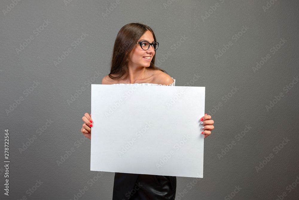 Beautiful woman holding a blank billboard isolated on gray background - inage Beautiful woman holding a blank billboard isolated on gray background - inage