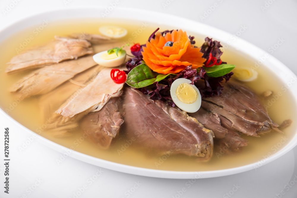Broth jelly with meat and vegetables. Banquet festive dishes. Gourmet restaurant menu. White background. Broth jelly with meat and vegetables. Banquet festive dishes. Gourmet restaurant menu. White background.
