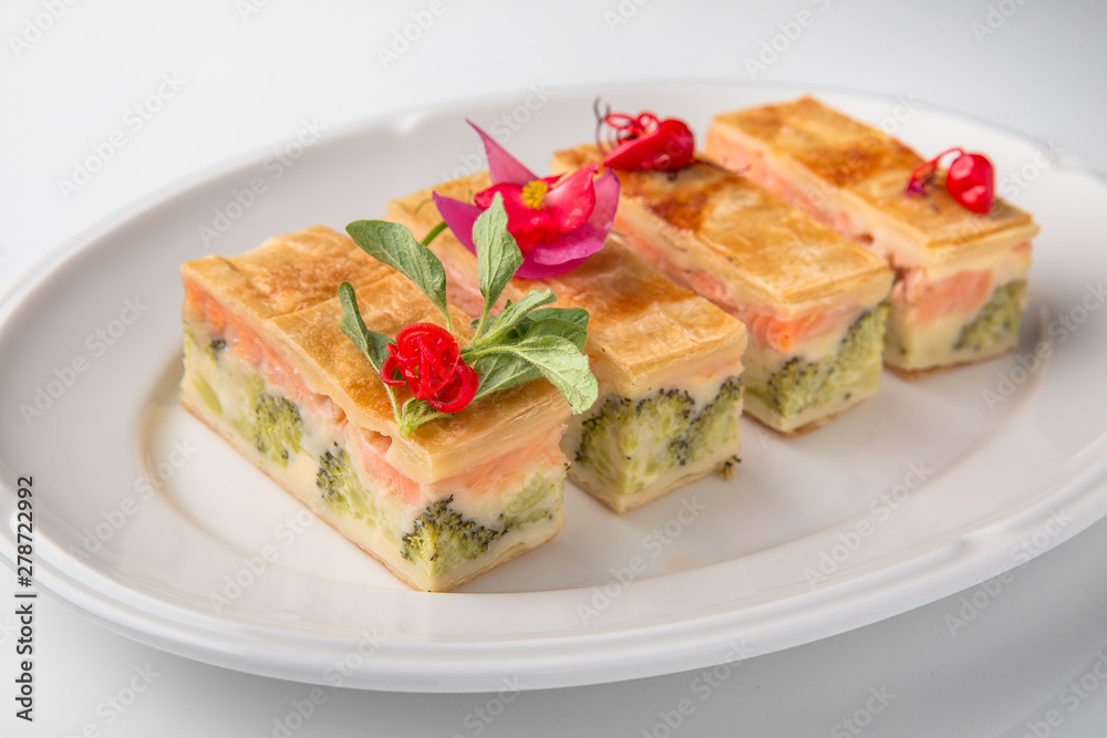 Quiche, casserole, delicious omelet from eggs, cheese, salmon, broccoli, spinach, pate. Banquet festive dishes. Gourmet restaurant menu. White background.
