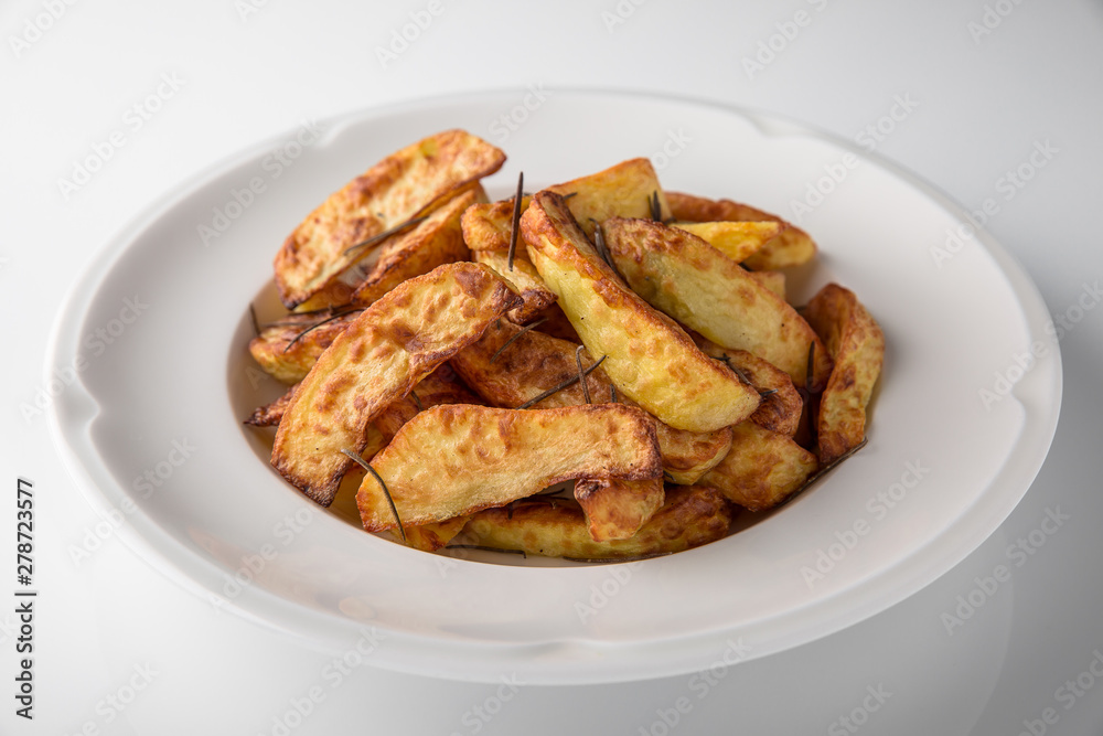 Home-made fried potato garnish. Banquet festive dishes. Gourmet restaurant menu. White background. Home-made fried potato garnish. Banquet festive dishes. Gourmet restaurant menu. White background.
