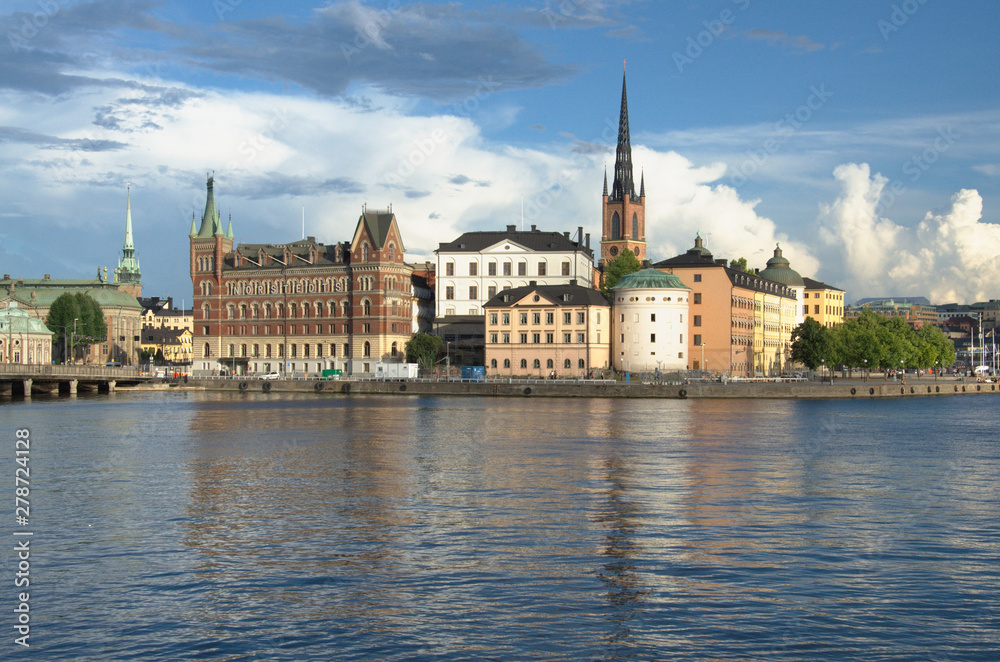 Beautiful scenic panorama of the Old City (Gamla Stan) cityscape pier architecture with historic town houses with colored facade, water and a cloudy Sky in Stockholm, Sweden.