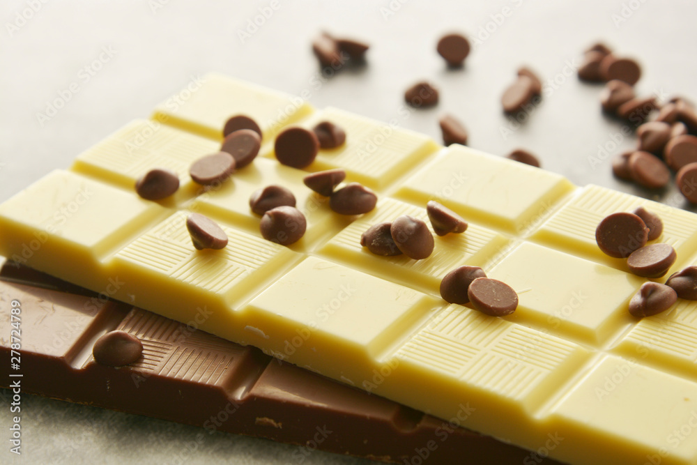 White and milk chocolate isolated. Top view of various chocolate bars with copy space. White and milk chocolate isolated. Top view of various chocolate bars with copy space.
