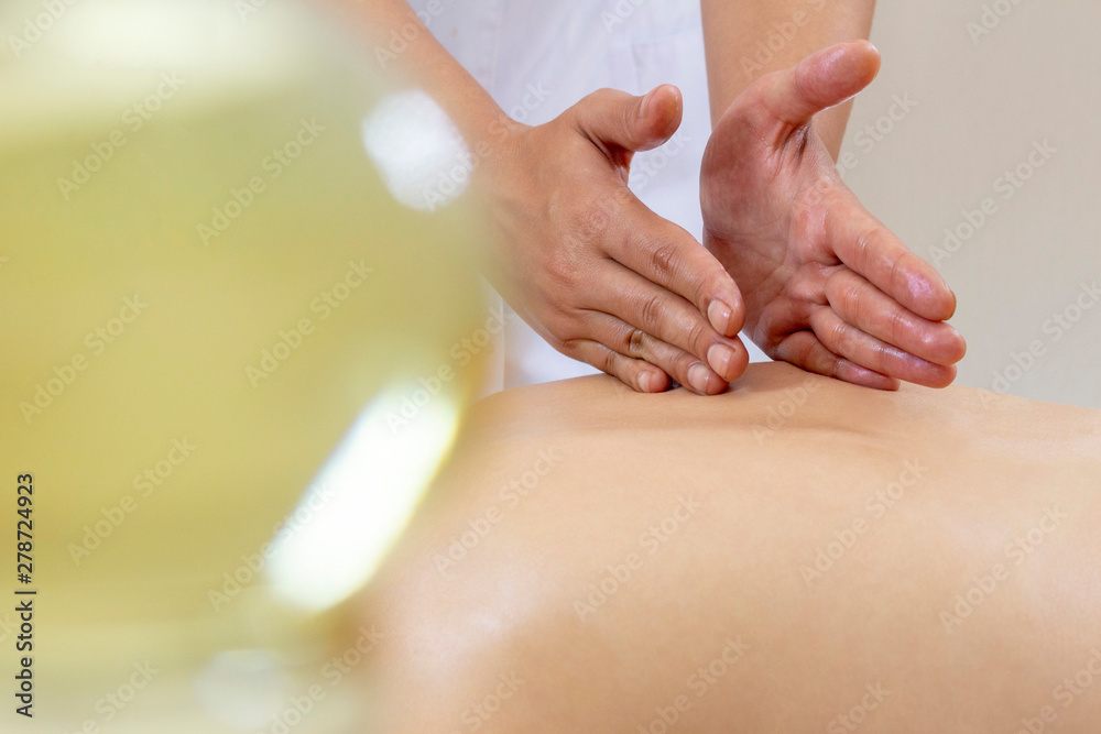 Spa massage. Female enjoying relaxing back massage in cosmetology spa centre. Body care, skin care, wellness, wellbeing, beauty treatment concept. Spa massage. Female enjoying relaxing back massage in cosmetology spa centre. Body care, skin care, wellness, wellbeing, beauty treatment concept.