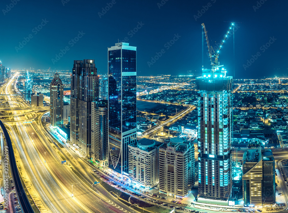 Obraz premium Downtown Dubai at night. Scenic aerial view on highways and skyscrapers.