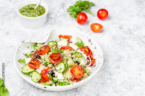mediterranean couscous salad with fried cherry tomatoes, cucumber