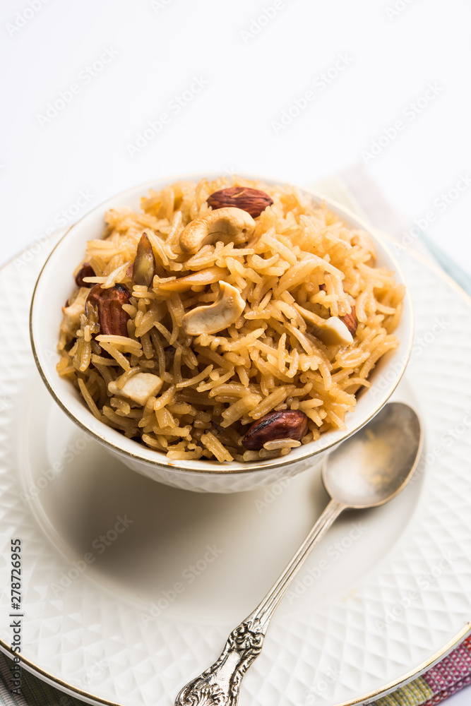 Traditional Jaggery Rice or Gur wale chawal in Hindi, served in a bowl with spoon. selective focus