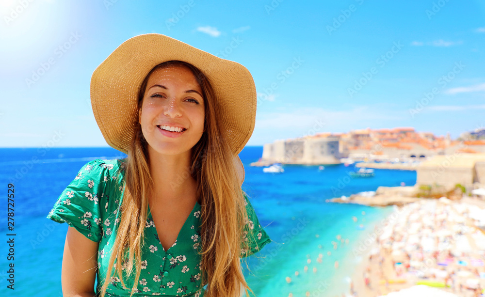 Happy attractive traveler woman in Croatia with Dubrovnik old city and Mediterranean sea on the background, Europe