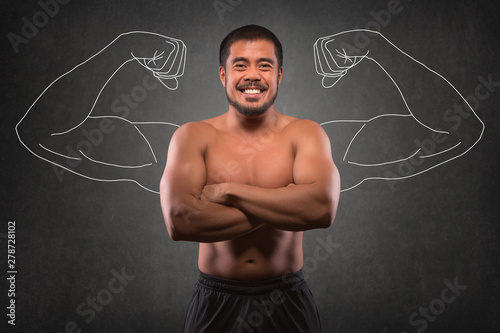 Smiling asian man with muscular upper body in front of muscle arms background. Fitness, workout and training concept.