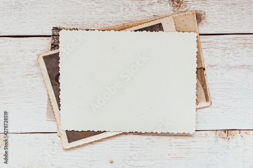 Old photos on wooden background. Blank old group photo