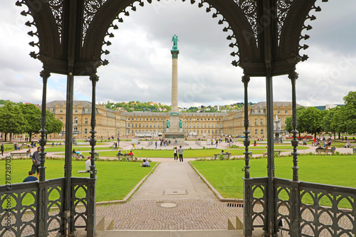 STUTTGART, GERMANY - JUNE 12, 2019: tourists in Schlossplatz with Jubiläumssäule column and the New Palace (Neues Schloss) photo