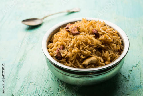 Traditional Jaggery Rice or Gur wale chawal in Hindi, served in a bowl with spoon. selective focus photo