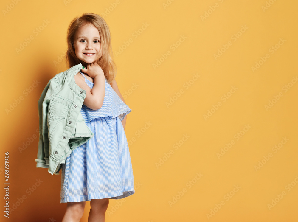 Full length portrait of a cute little child girl in a stylish dress and denim. - obrazy, fototapety, plakaty 