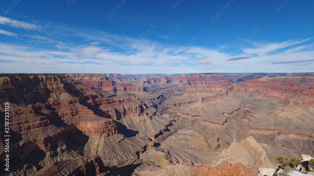 View of the Grand Canyon under a complex cloudscape from the South Rim Trail in Grand Canyon National Park, Arizona, in winter.