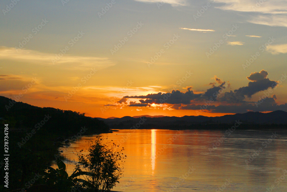 Tradition of Long tail boat and fisherman in beautiful sunset twilight at Khong river the Thai-Laos border Chaingkhan distric Thailand Tradition of Long tail boat and fisherman in beautiful sunset twilight at Khong river the Thai-Laos border Chaingkhan distric Thailand