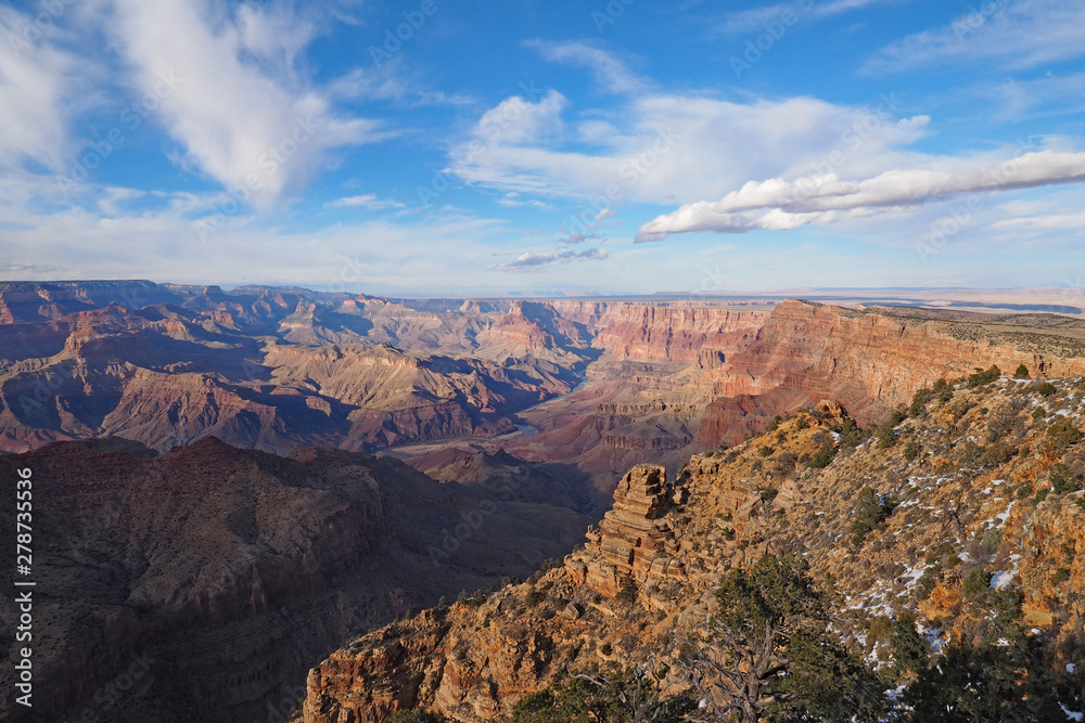 View of the Grand Canyon under a complex cloudscape from the South Rim Trail in Grand Canyon National Park, Arizona, in winter.