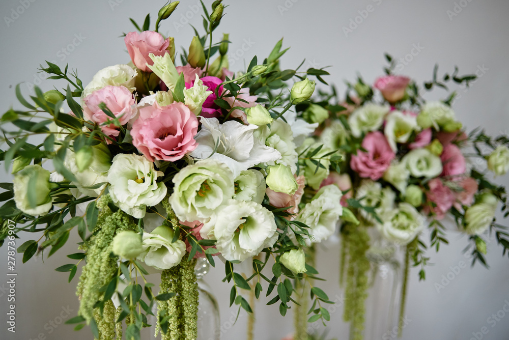 Luxury floral arrangement of pink and white flowers in glass vases, copy space. Wedding decorations, holiday concept
