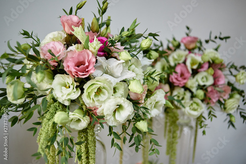 Luxury floral arrangement of pink and white flowers in glass vases, copy space. Wedding decorations, holiday concept