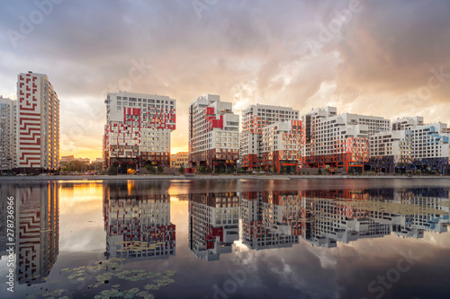 Moscow, Russia. View of new modern residential buildings reflecting in water on sunset in Nagatinsky Zaton district photo