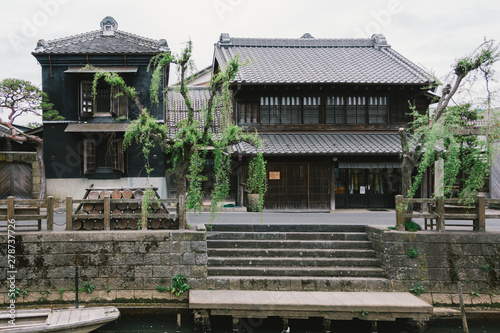 Old vintage wooden Japanese house along small street by Tonegawa river in Sawara village, famous little Edo old town. photo