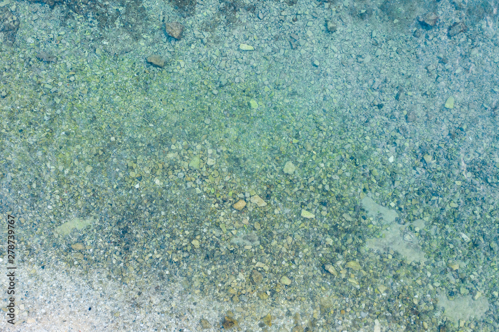 Aerial view of rocky beach at the sea and the turquoise ocean shore Aerial view of rocky beach at the sea and the turquoise ocean shore