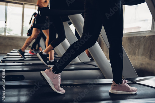 Close up shoe and legs. Asian women running in a gym on a treadmill.