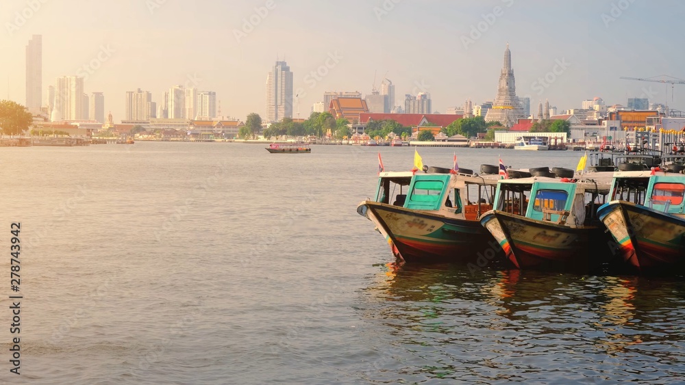 Colorful Passenger Boats Docked with Wat Arun at on the Chao Phraya River.