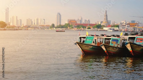 Colorful Passenger Boats Docked with Wat Arun at on the Chao Phraya River.