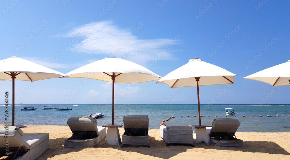 Deck chairs and umbrellas in a beach during the summer