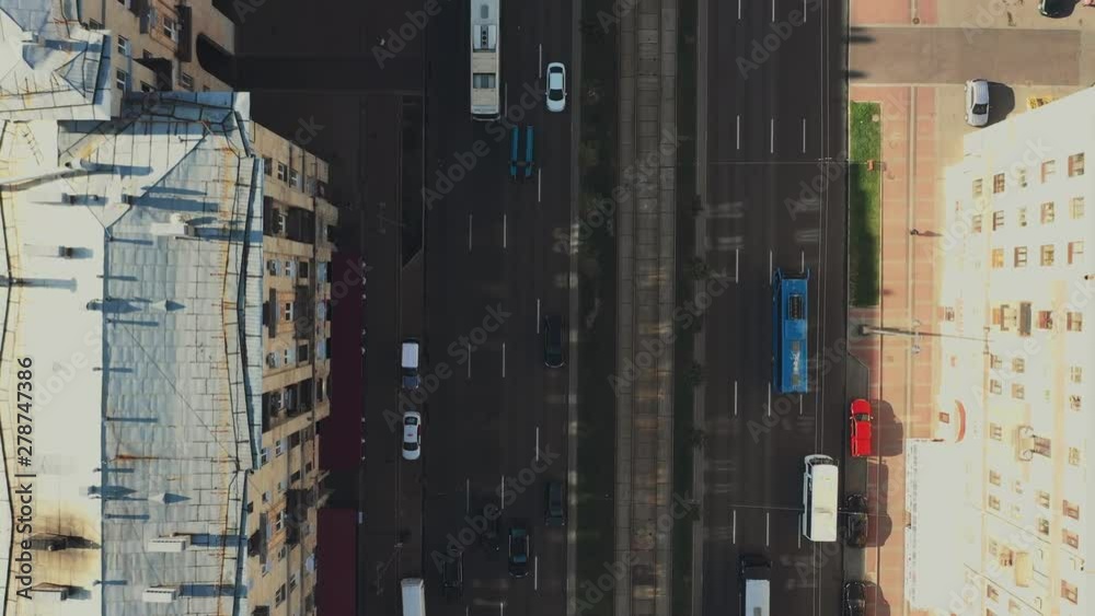 AERIAL. Hight speed flight above of a two-way road section circling the height of storied houses AERIAL. Hight speed flight above of a two-way road section circling the height of storied houses