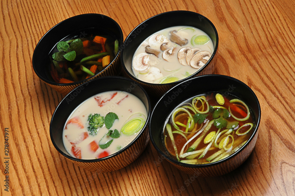 Japanese Cuisine - Miso Soup with vegetables and Tofu Cheese on a wooden table. Soup set Japanese Cuisine - Miso Soup with vegetables and Tofu Cheese on a wooden table. Soup set