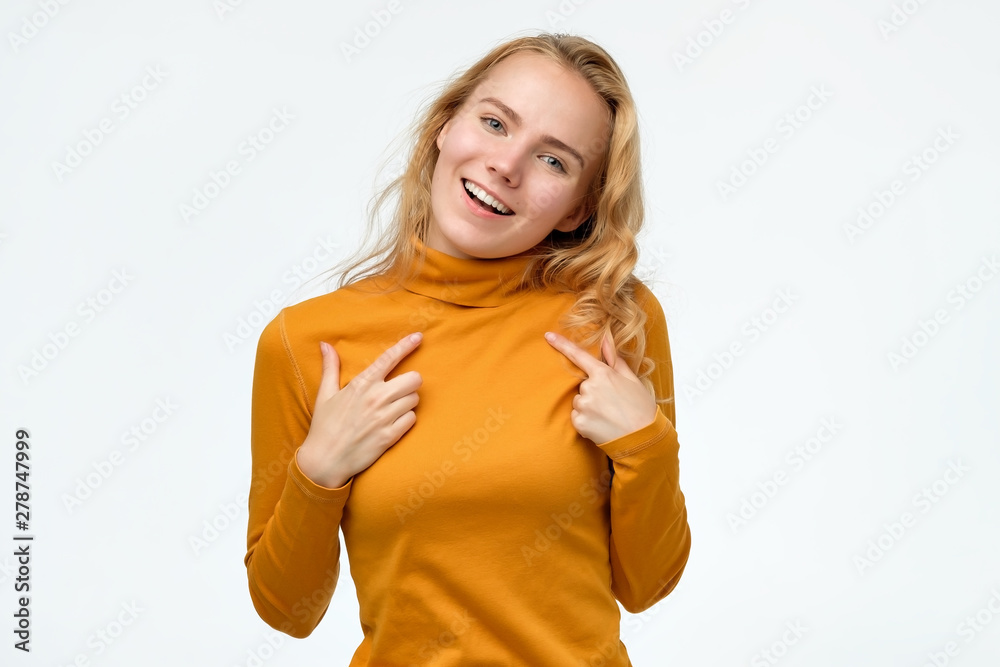 Happy young teenager woman pointing fingers at herself. Select me please concept. She can not believe in her luck