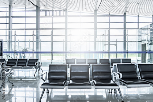Empty passenger waiting seat in airport departure gate  Front view seating with glass background
