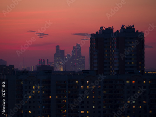 Dark cityscape landscape with skyscrapers at sunset