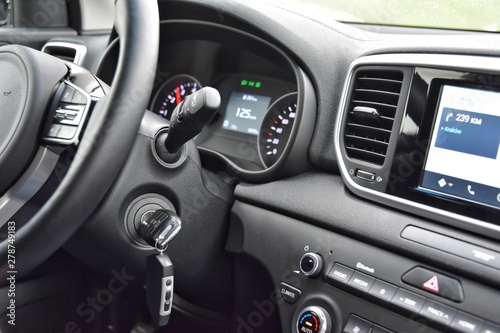  Car interior with luxury dashboard and leather steering wheel. Information screen on the dashboard. Electronic navigator system. dashboard with touchscreen system and gps