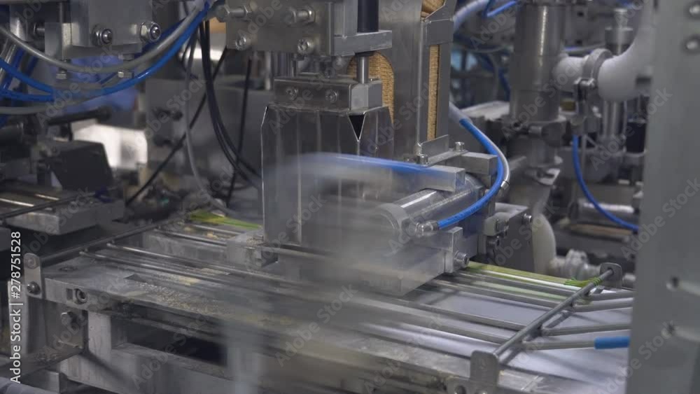 Ice Cream Production Line. Filling waffle cups with ice cream. ice cream factory vanilla chocolate fridge, packaging, waffle cups Ice Cream Production Line. Filling waffle cups with ice cream. ice cream factory vanilla chocolate fridge, packaging, waffle cups
