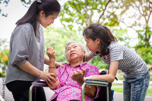 Sick senior grandmother with epileptic seizures in outdoor,elderly patient convulsions suffering from illness with epilepsy during seizure attack,asian daughter,granddaughter cry,family care concept