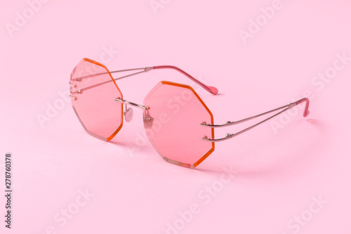Creative pink trendy sunglasses on pastel background