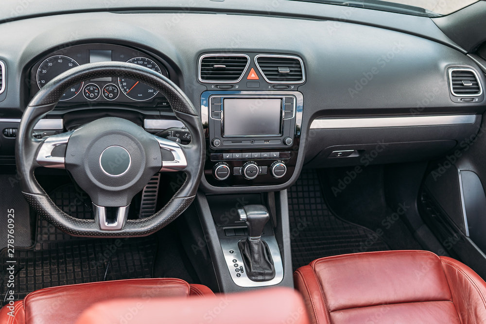 Luxury car interior with dashboard, steering wheel and leather seats Luxury car interior with dashboard, steering wheel and leather seats