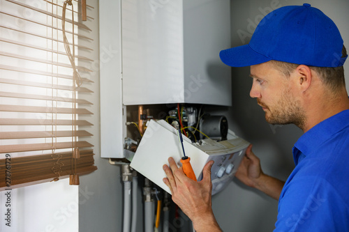 Billede på lærred maintenance and repair service engineer working with house gas heating boiler