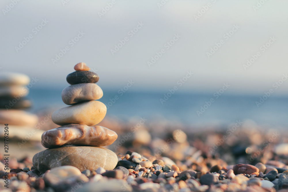 Stones tower with blurred sea background. Zen garden. Spa set.	 Your text space. 